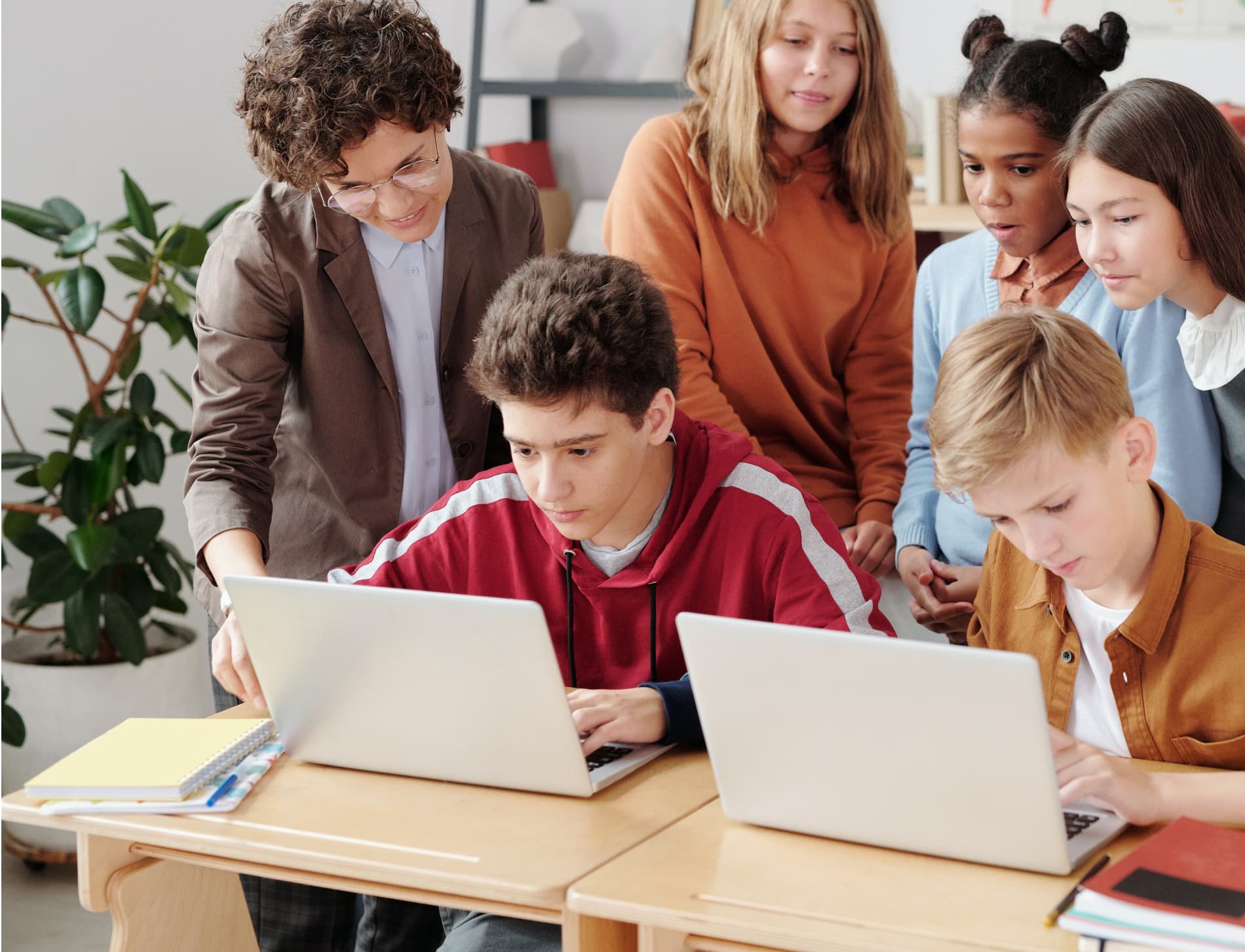 Group of students engaged in collaborative learning with laptops