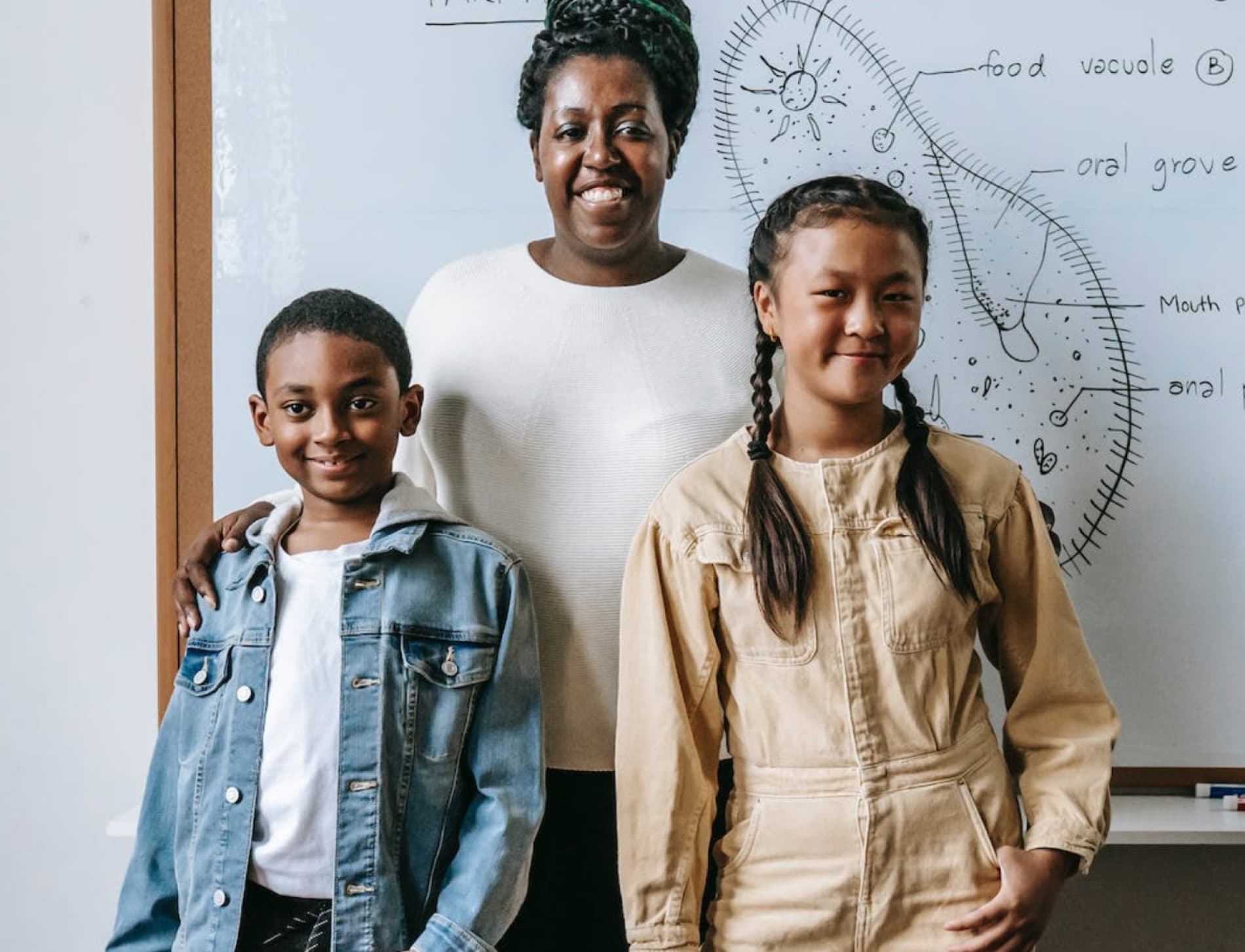 Students with teacher smiling in a classroom